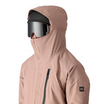The 686 Gore-Tex GT shell jacket in tan has a full-length zipper and an insulated hood.
