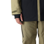 The 686 Gore-Tex GT shell jacket in khaki and black has an insulated hood.