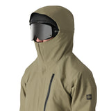 The 686 Gore-Tex GT shell jacket in khaki and black has an insulated hood, zippered chest pocket, and front zipper.