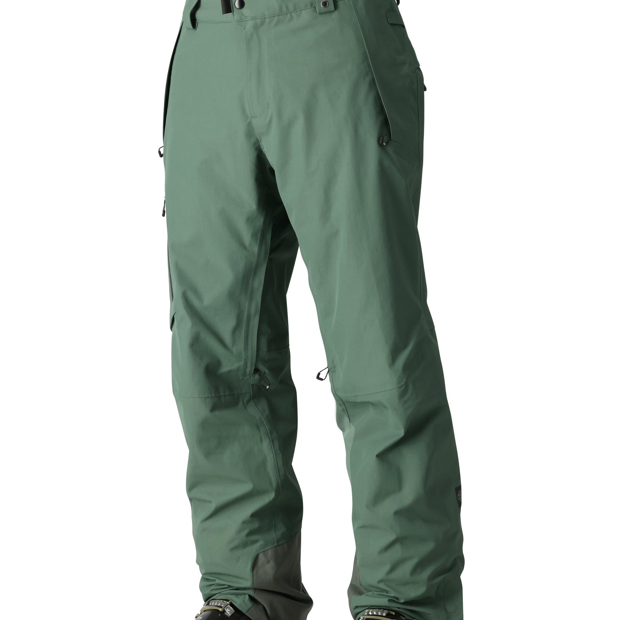 The 686 Men's GORE-TEX GT Pant 2025 is shown in a forest green color with a zippered fly and adjustable Velcro straps at the waist.