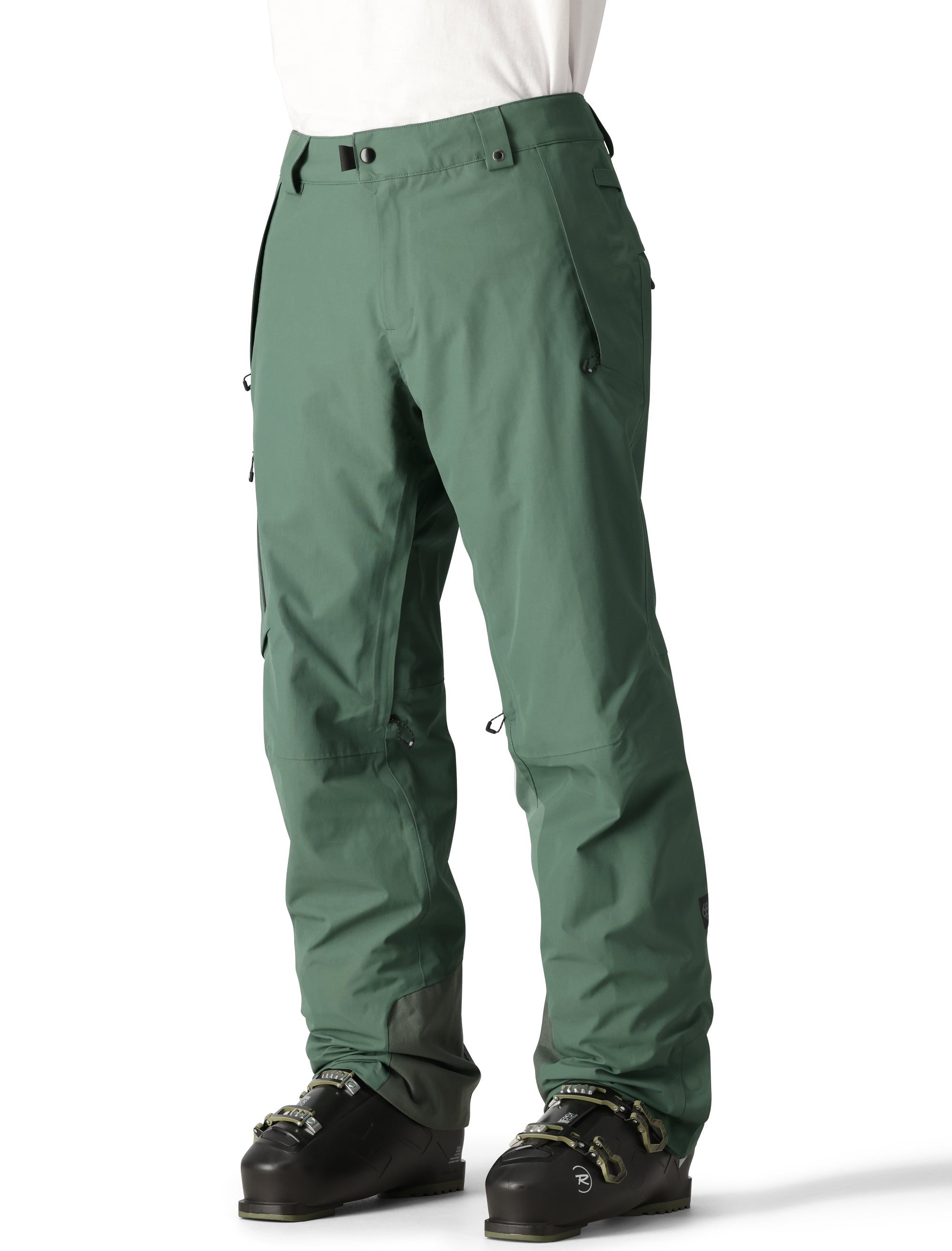 The 686 Men's GORE-TEX GT Pant 2025 is shown in a forest green color with a zippered fly and adjustable Velcro straps at the waist.