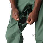 The 686 Men's GORE-TEX GT Pant 2025 is depicted in forest green with a black waistband and belt loops on both sides of the front view.