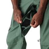 The 686 Men's GORE-TEX GT Pant 2025 is depicted in forest green with a black waistband and belt loops on both sides of the front view.
