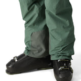 The 686 Men's GORE-TEX GT Pant 2025 appears in a front view with a dark green color and grey patch on the leg.