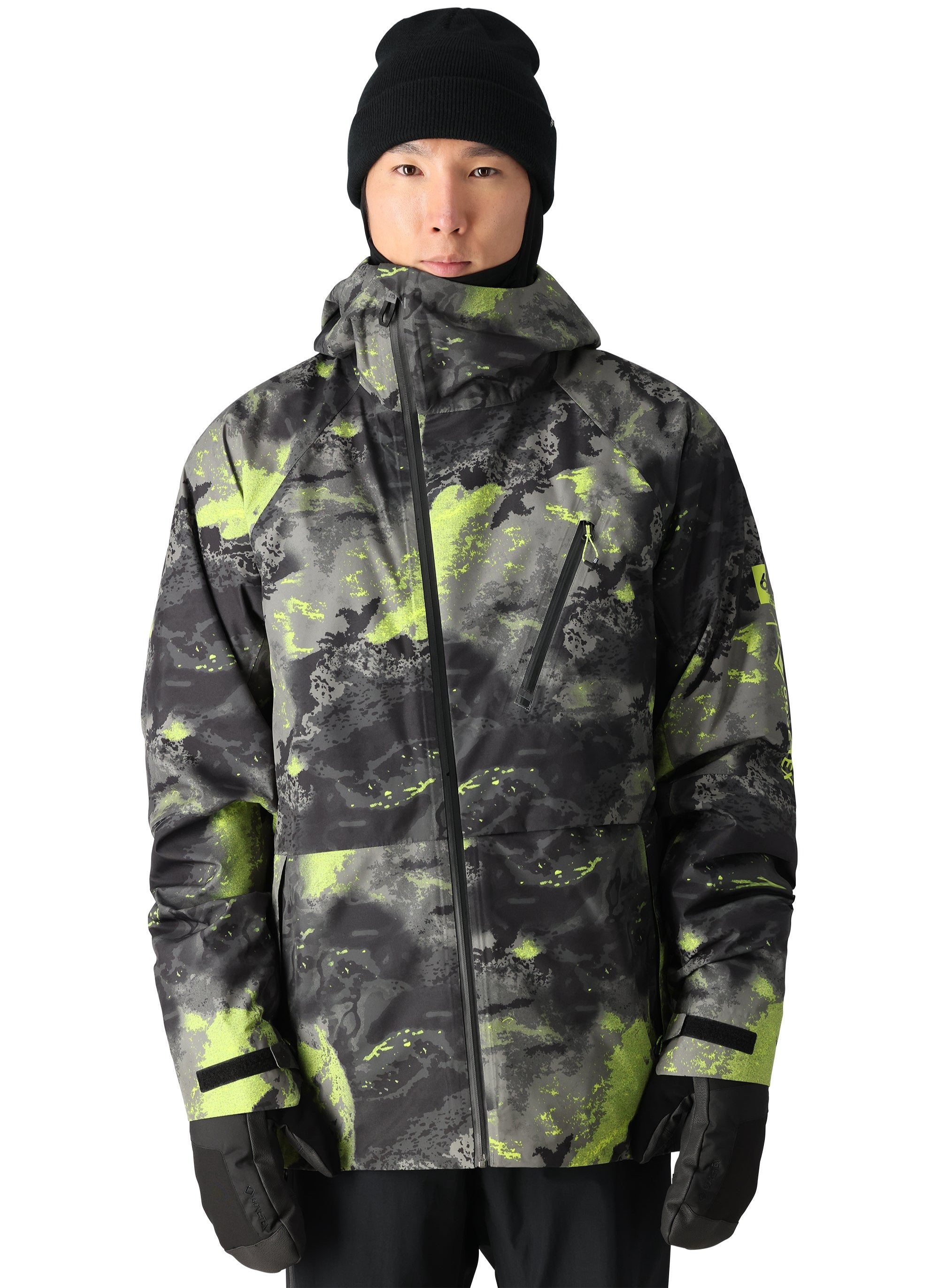 The 686 Gore-Tex Hydra Down Thermagraph jacket has a black base color with neon green splatter accents.
