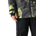 The 686 Gore-Tex Hydra Down Thermagraph jacket features a black body with bright green abstract designs and accents.
