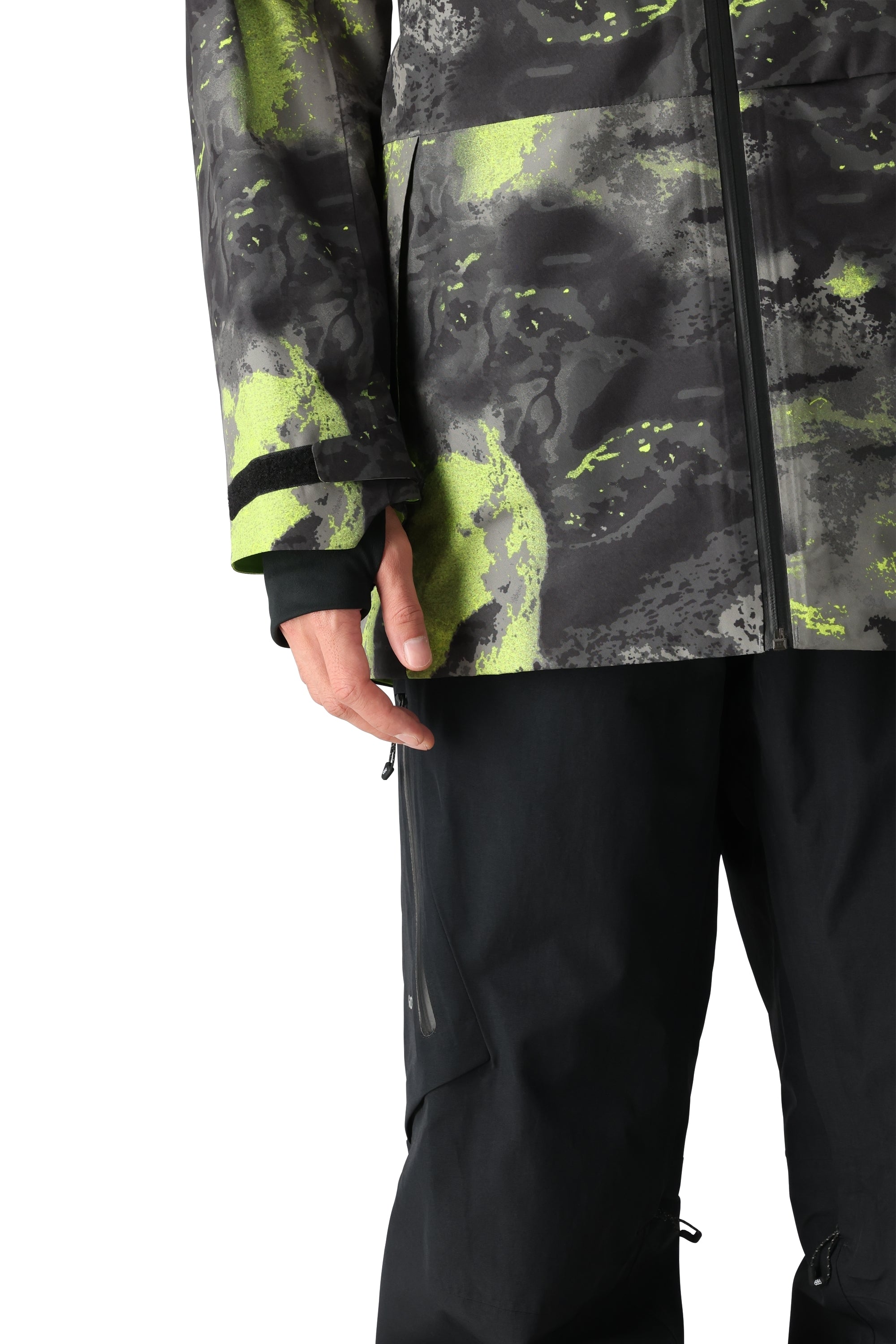 The 686 Gore-Tex Hydra Down Thermagraph jacket features a black body with bright green abstract designs and accents.