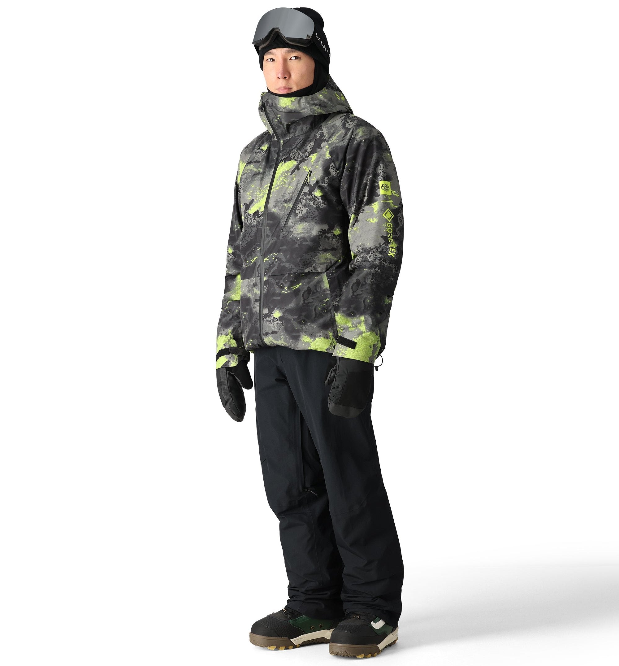 The 686 Gore-Tex Hydra Down Thermagraph jacket features a black and green camouflage pattern with a high collar and zippered front.