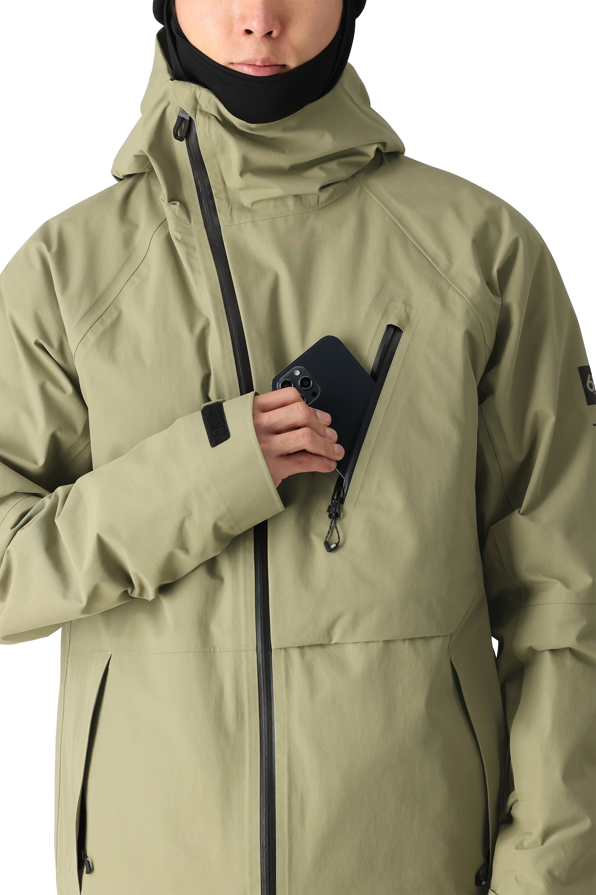The 686 Gore-Tex Hydra Down Thermagraph jacket in khaki has an insulated hood and black zipper.