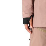 The 686 Women's GORE-TEX Skyline Shell Jacket 2025 is primarily tan with black accents and a zippered front.