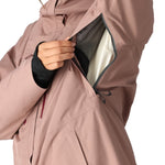The 686 Women's GORE-TEX Skyline Shell Jacket 2025 is shown in a dusty rose color with a black zipper and a white fleece lining.