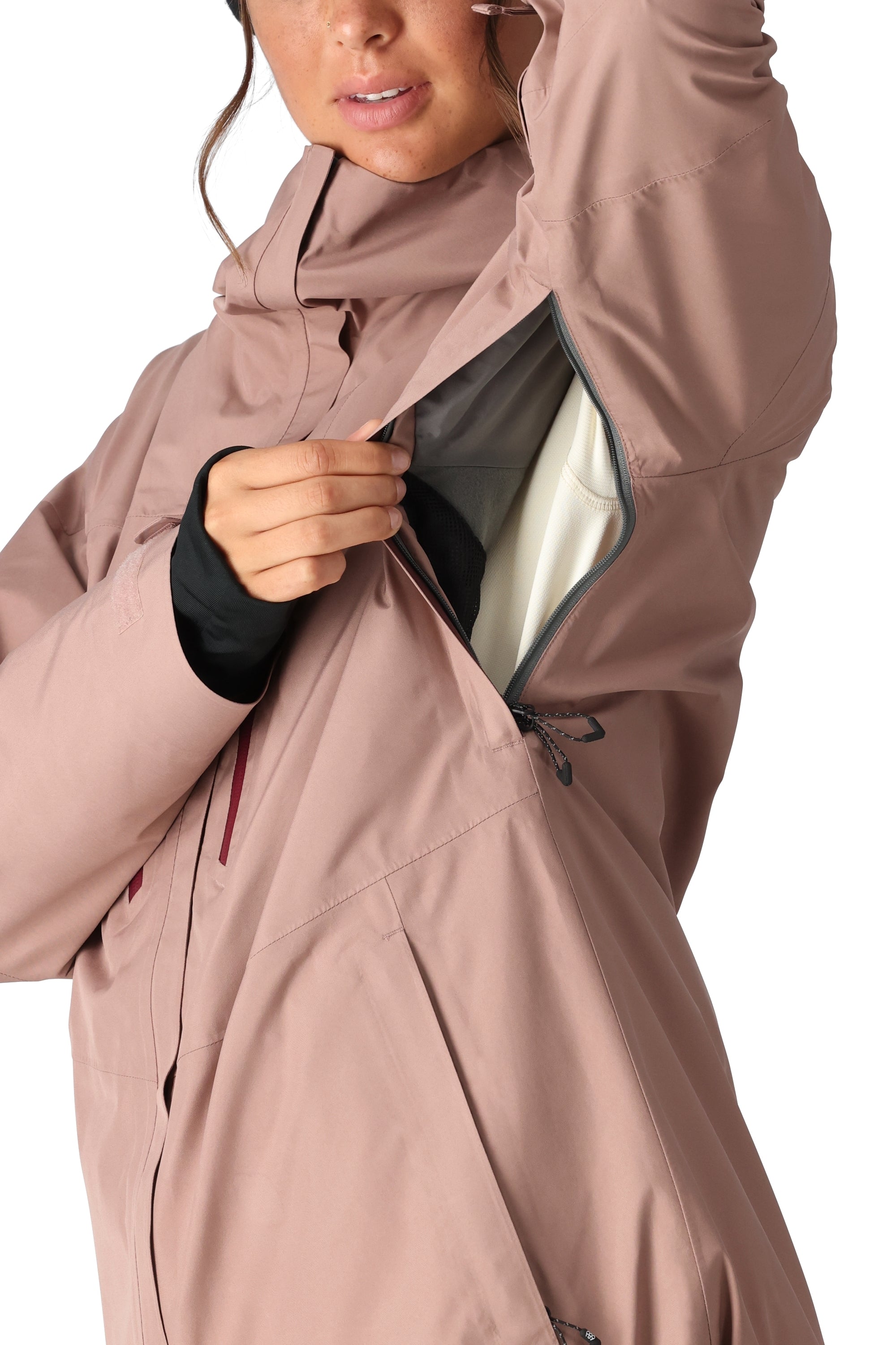 The 686 Women's GORE-TEX Skyline Shell Jacket 2025 is shown in a dusty rose color with a black zipper and a white fleece lining.