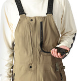 The 686 Men's GORE-TEX Stretch Dispatch Bib 2025 features a khaki bib with black suspenders and multiple zippered pockets.