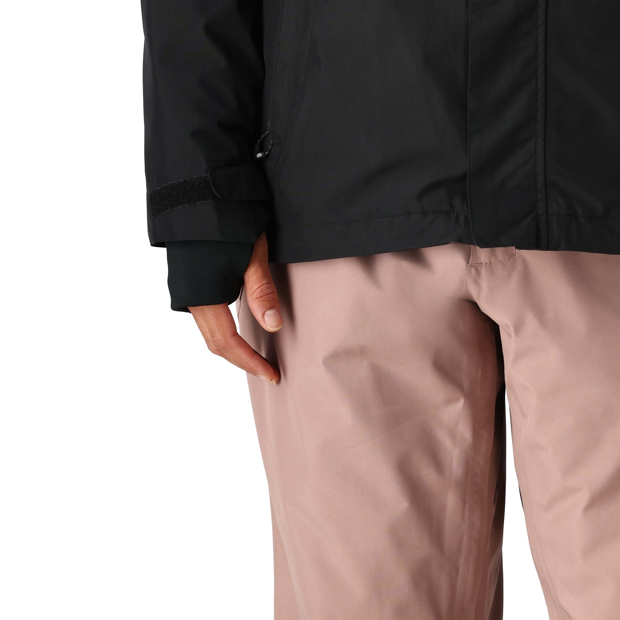 The 686 Women's GORE-TEX Willow Insulated Jacket 2025 is shown in black and pink, with a visible zipper at the waist.