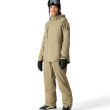 The 686 Willow insulated jacket has a tan color with a hood and front zipper.