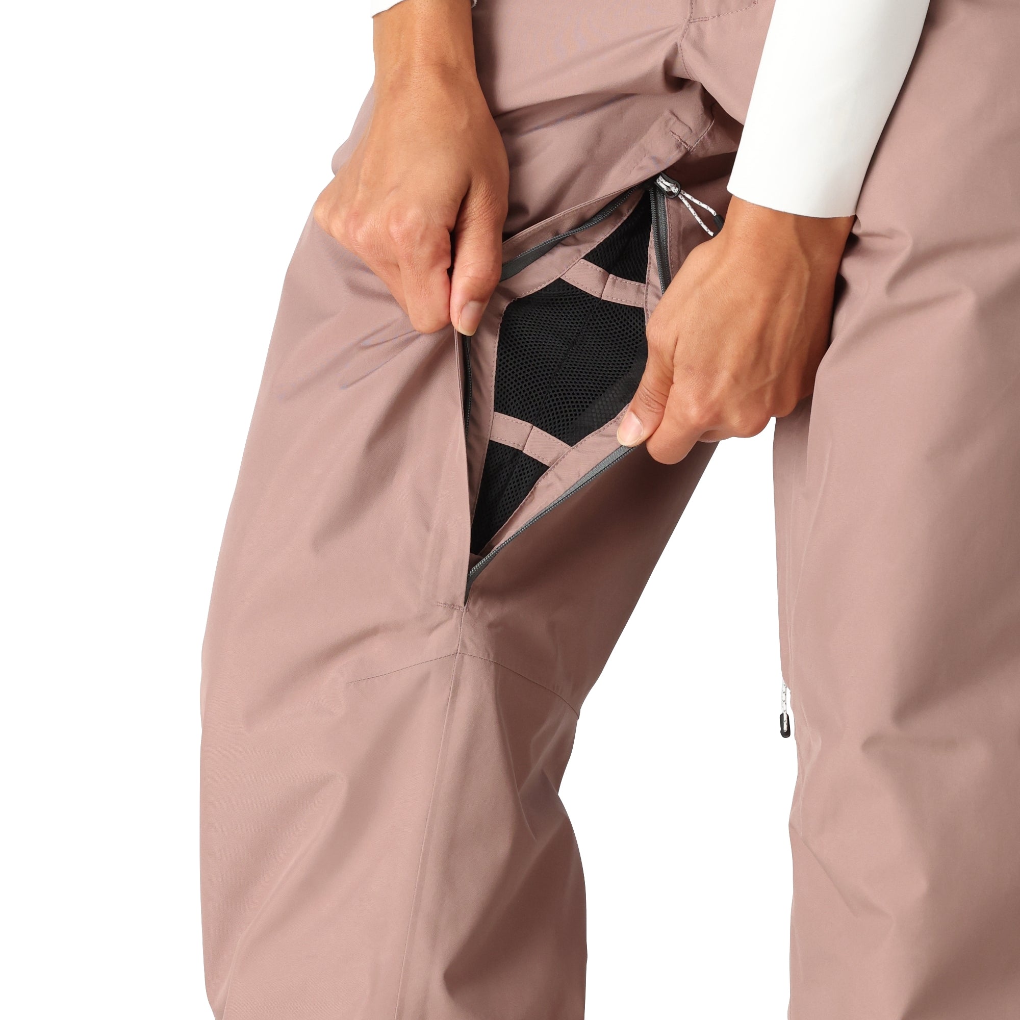 The 686 Women's GORE-TEX Willow Insulated Pant 2025 is primarily brown with black accents and a zippered pocket on the front.