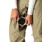 The 686 Women's GORE-TEX Willow Insulated Pant 2025 is primarily khaki with a black mesh lining and zippered pocket on the back.