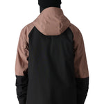 The 686 Hydra Thermagraph jacket in black and brown has an insulated hood with a zippered front closure.