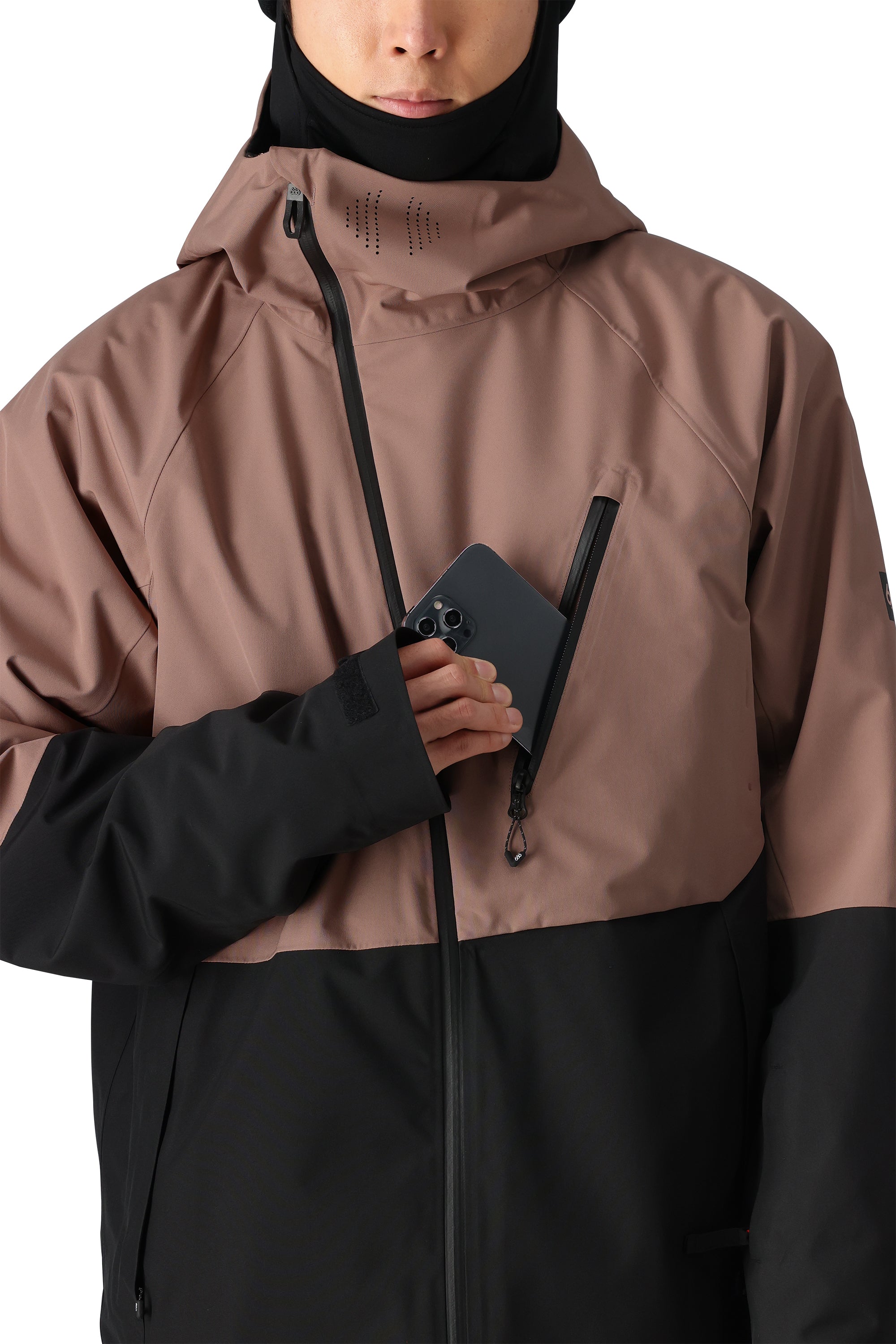 The 686 Hydra Thermagraph Jacket in brown and black has an insulated hood with a drawstring.