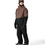 The 686 Hydra Thermagraph Jacket in brown and black has an insulated hood and multiple zippered pockets on the front.