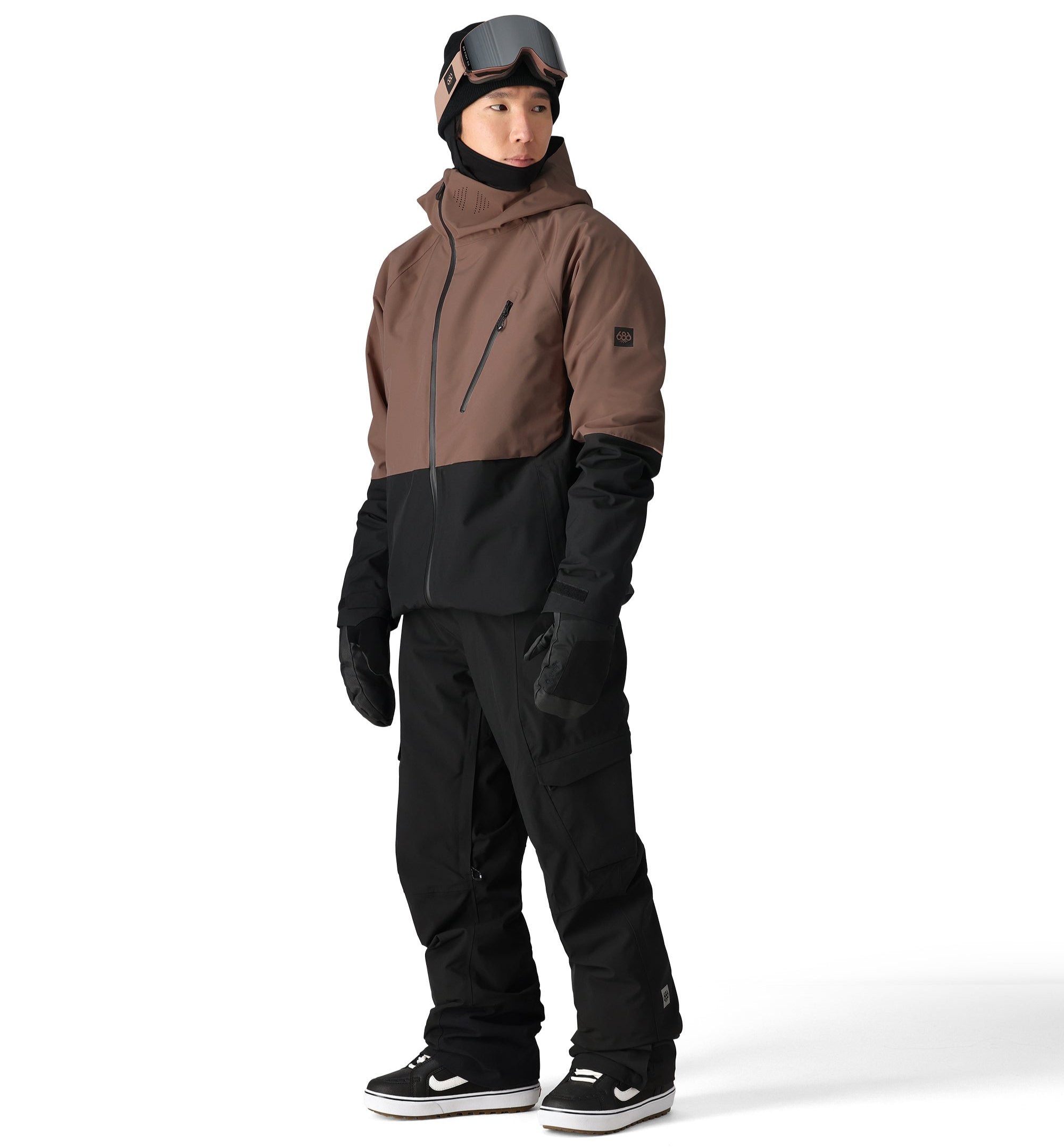 The 686 Hydra Thermagraph Jacket in brown and black has an insulated hood and multiple zippered pockets on the front.