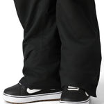 The 686 Men's Infinity Insulated Cargo Pant 2025, shown in black, has a visible zippered cargo pocket on one leg.