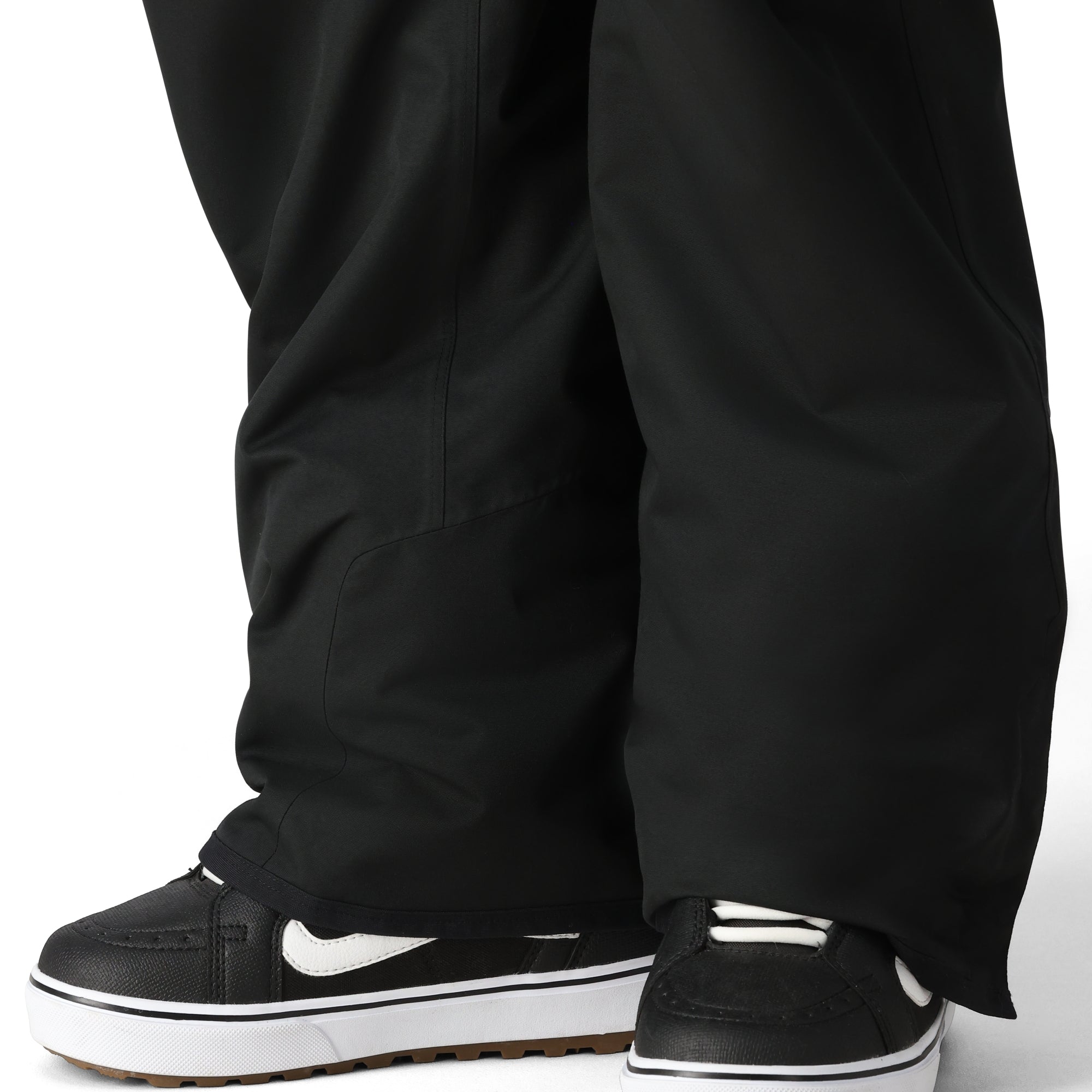 The 686 Men's Infinity Insulated Cargo Pant 2025, shown in black, has a visible zippered cargo pocket on one leg.