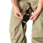 The 686 Men's Infinity Insulated Cargo Pant 2025 is shown in khaki with two zippered front pockets and a distinctive cargo pocket on each leg.