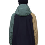 The 686 Gore-Tex Core Shell Jacket in black and tan has a hood with an insulated panel.