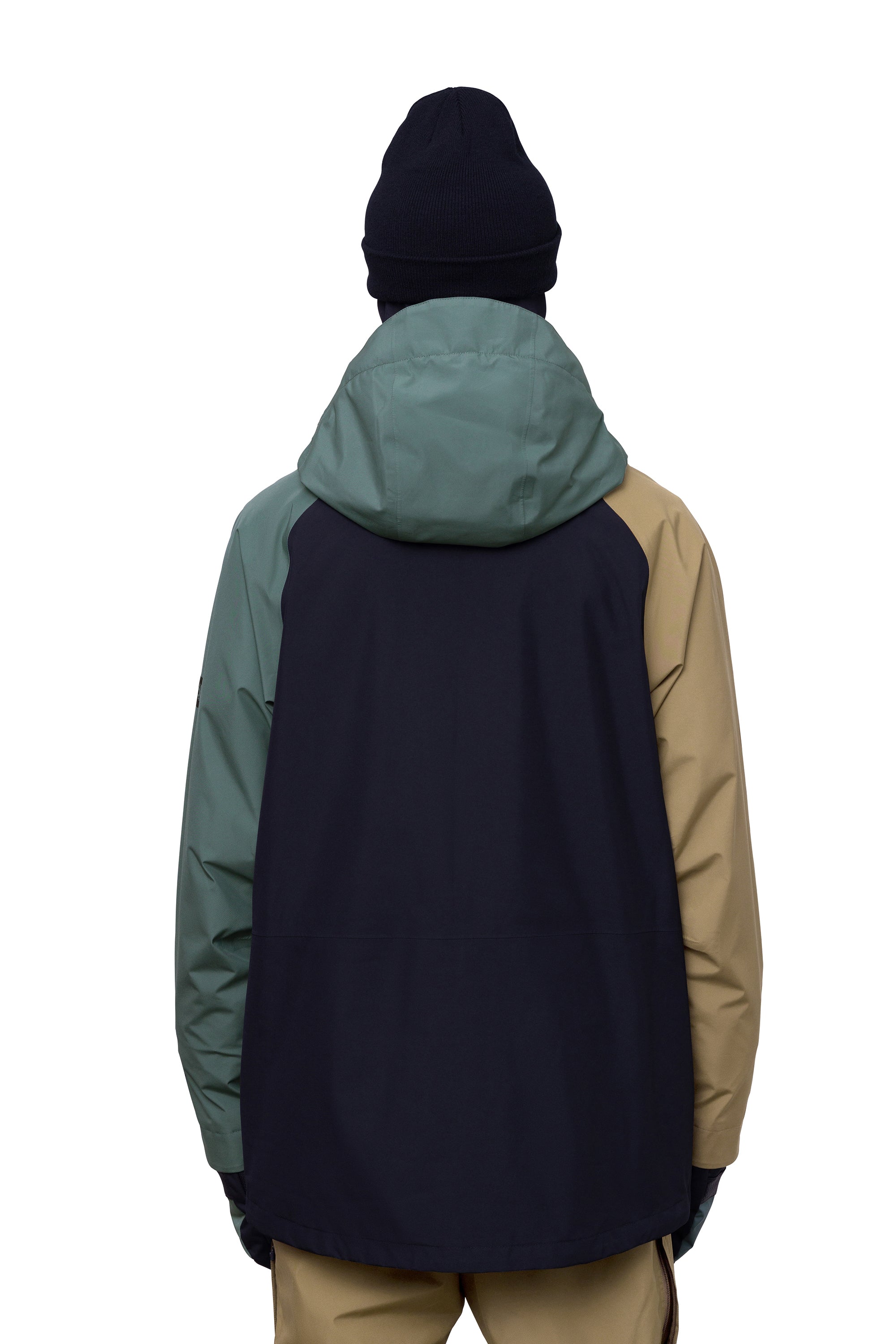 The 686 Gore-Tex Core Shell Jacket in black and tan has a hood with an insulated panel.