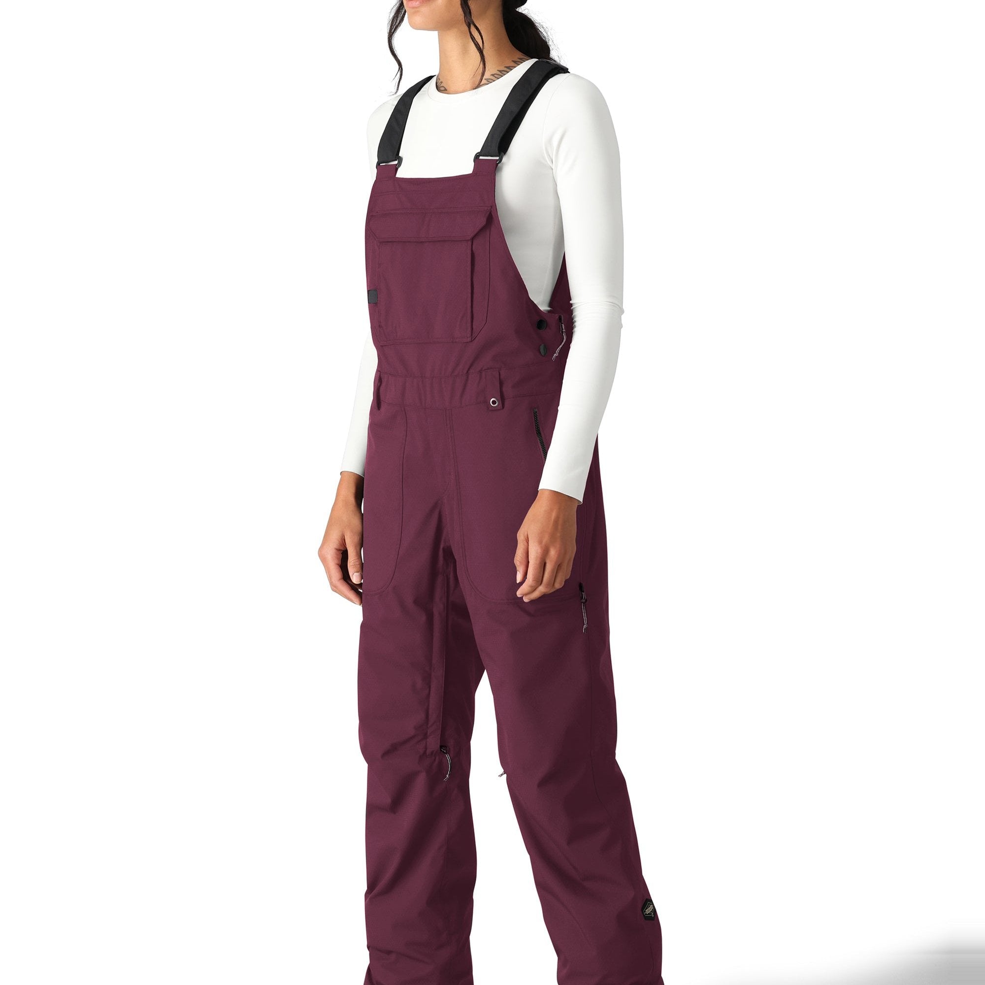 The 686 Black Magic Insulated Bib Pants are showcased in this image from the front view, with a solid black color.