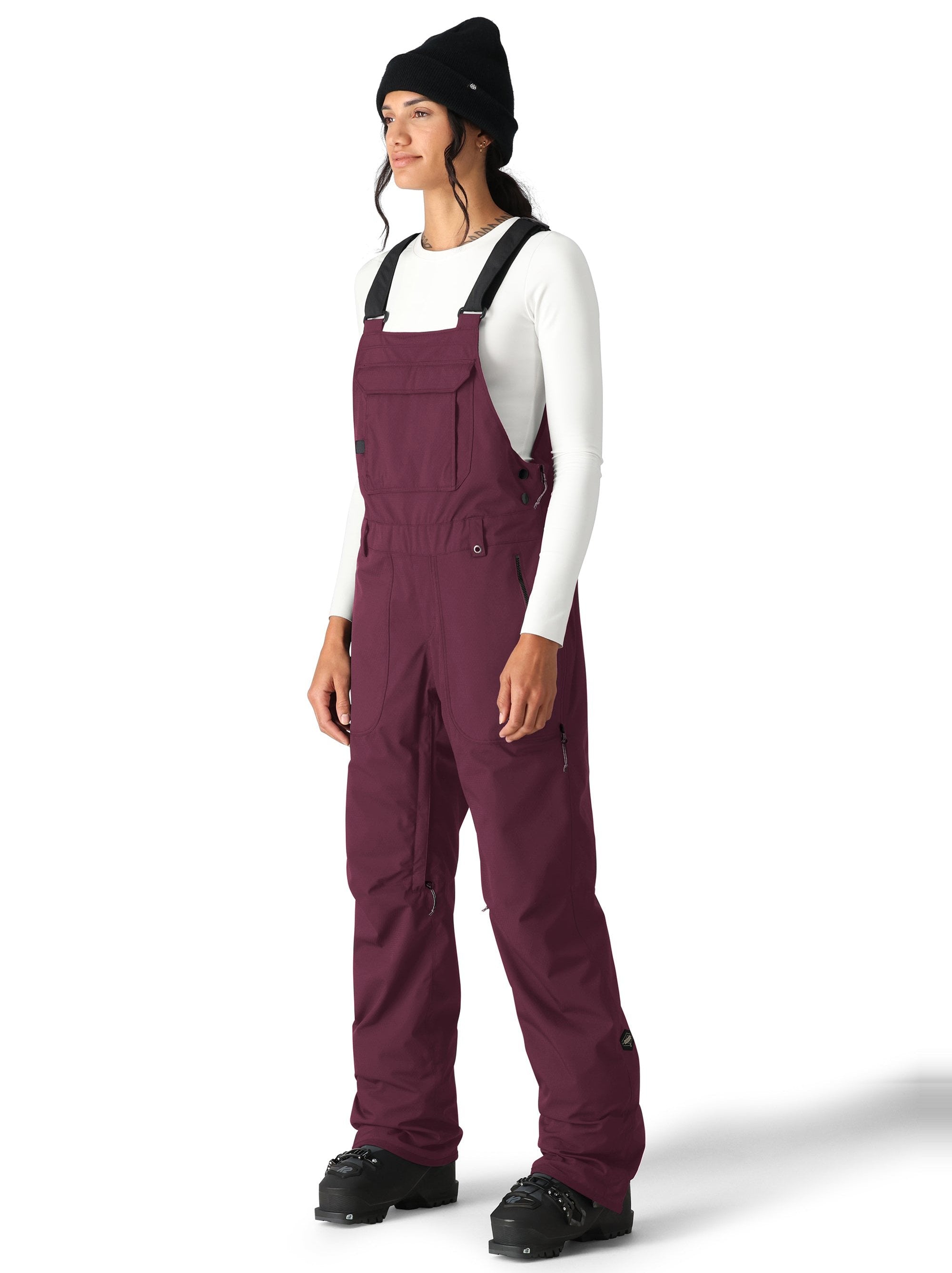 The 686 Black Magic Insulated Bib Pants are showcased in this image from the front view, with a solid black color.
