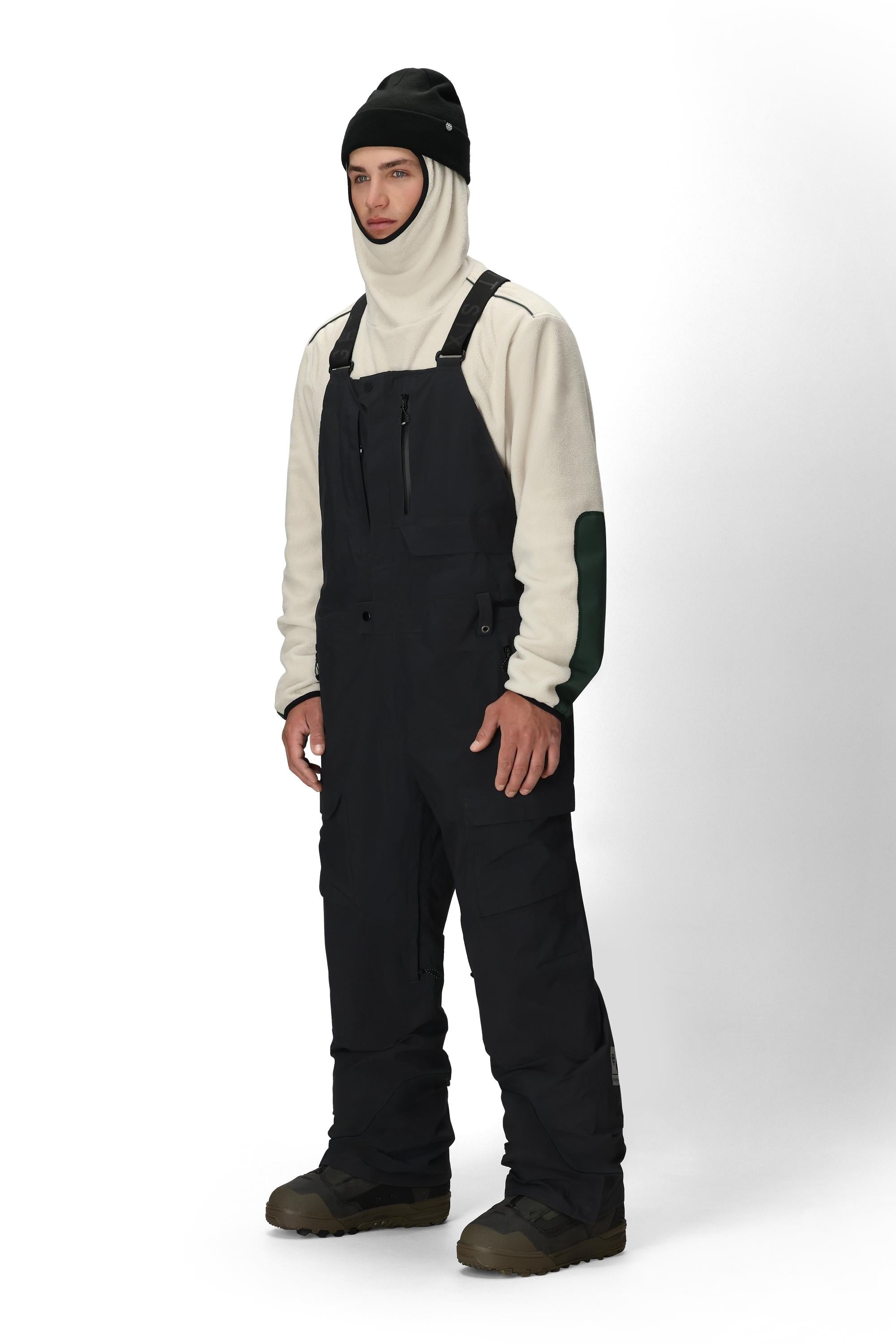 Men's black bib overalls with adjustable suspenders, knee panels, and front zipper