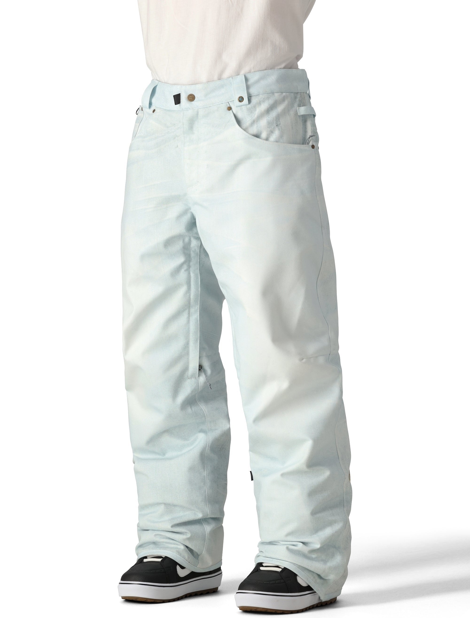 The 686 Deconstructed Denim Insulated Pant 2025 is light blue with an adjustable waistband and multiple pockets.
