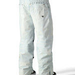 The 686 Deconstructed Denim Insulated Pant 2025 is light blue with an adjustable waistband and zippered pockets.
