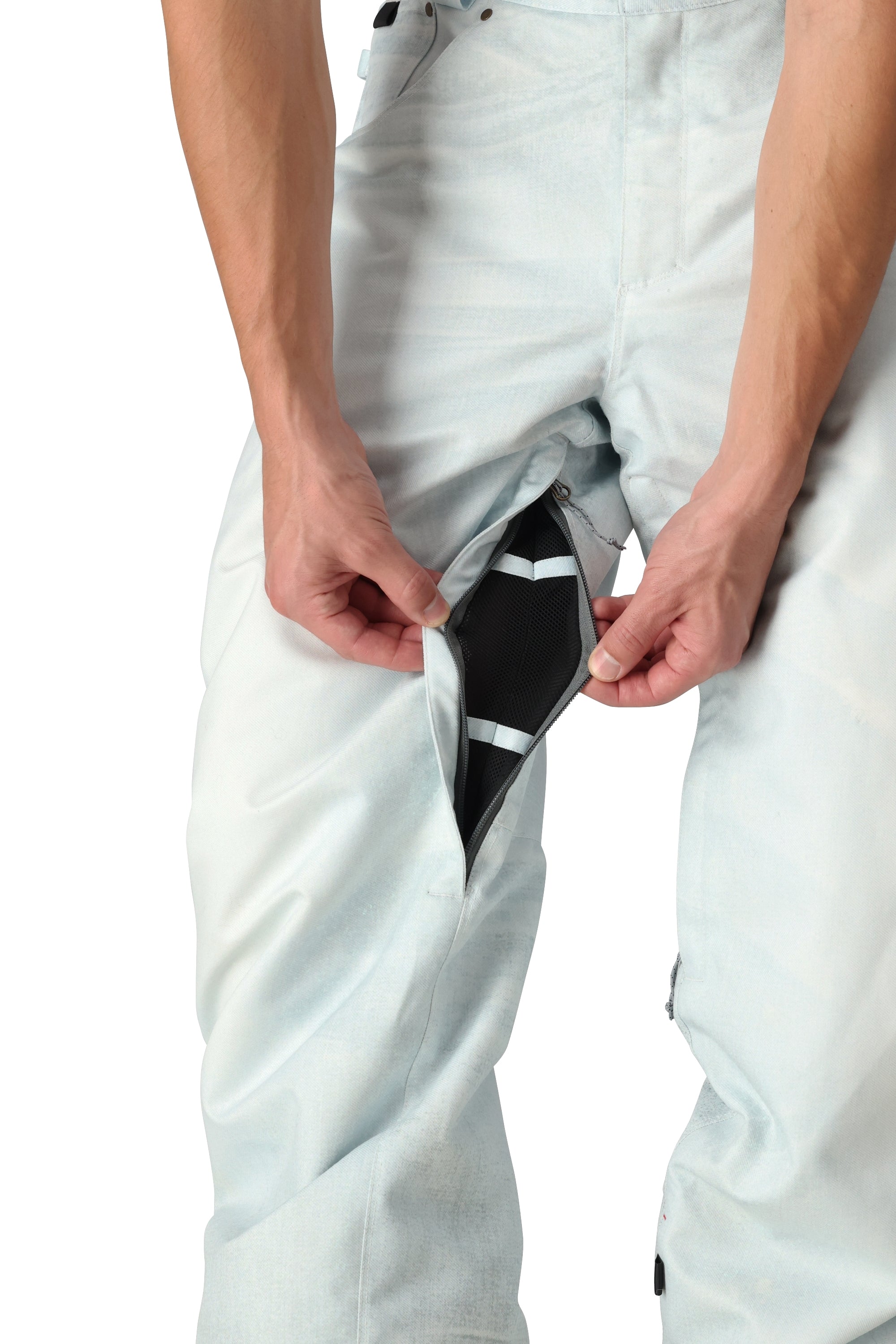 The 686 Deconstructed Denim Insulated Pant 2025 has a light blue color with a distinctive black and white striped pattern on the side view.