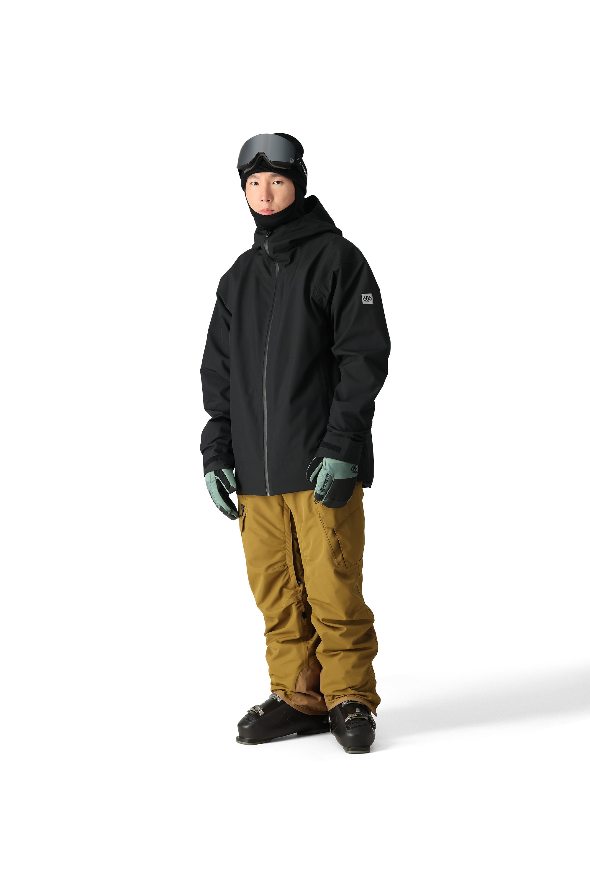 The 686 Gateway Shell Jacket 2025 is black with a high collar and zippered pockets.
