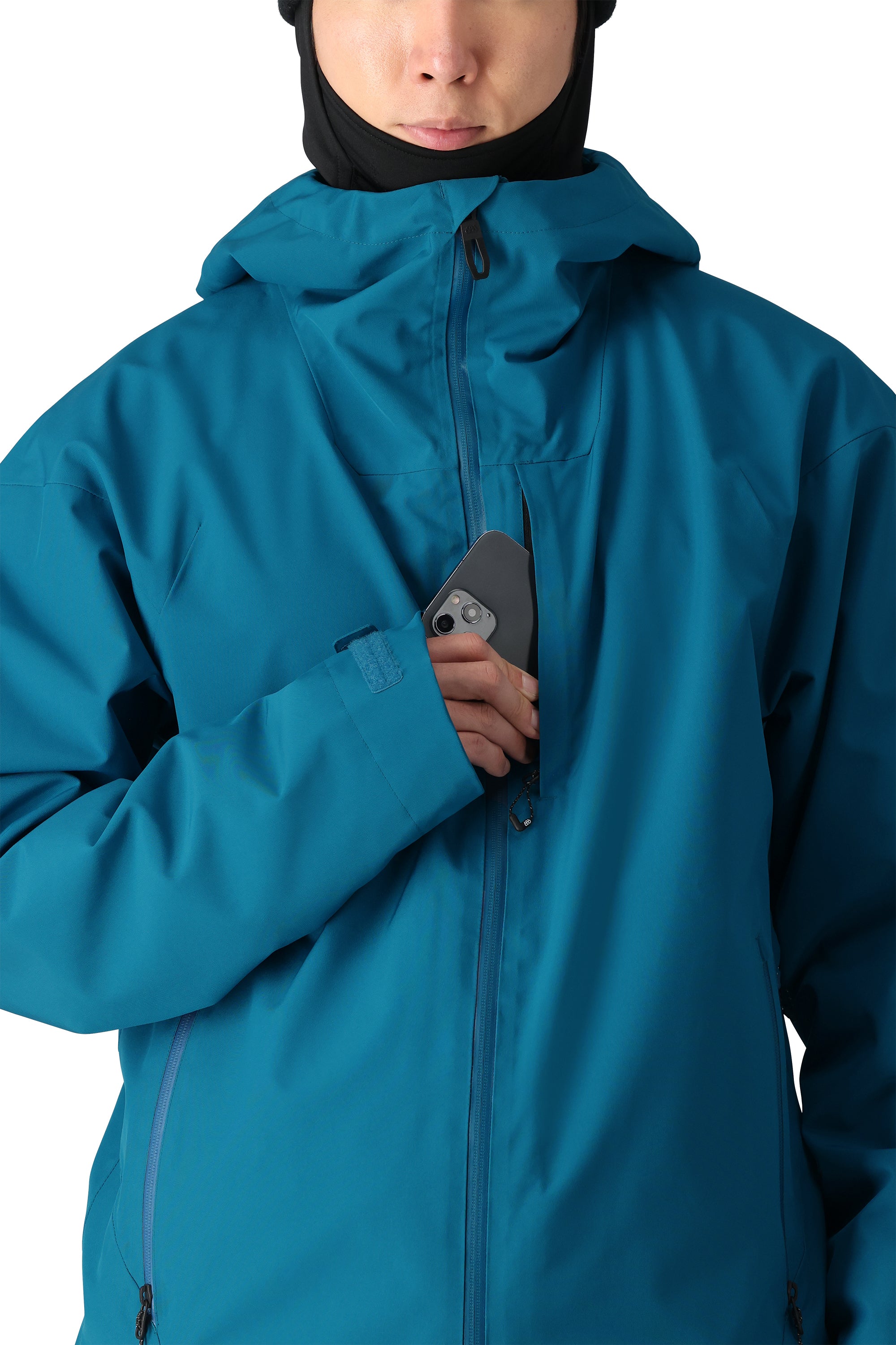 The 686 Gateway Shell Jacket 2025 is showcased in this image, featuring a rich blue color and an insulated hood.