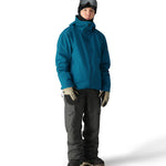 The 686 Gateway Shell Jacket 2025 is primarily blue-green with black accents and has an adjustable hood.