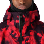 The 686 Gateway Shell Jacket 2025 is predominantly red with black accents and has a black zipper running down the front.