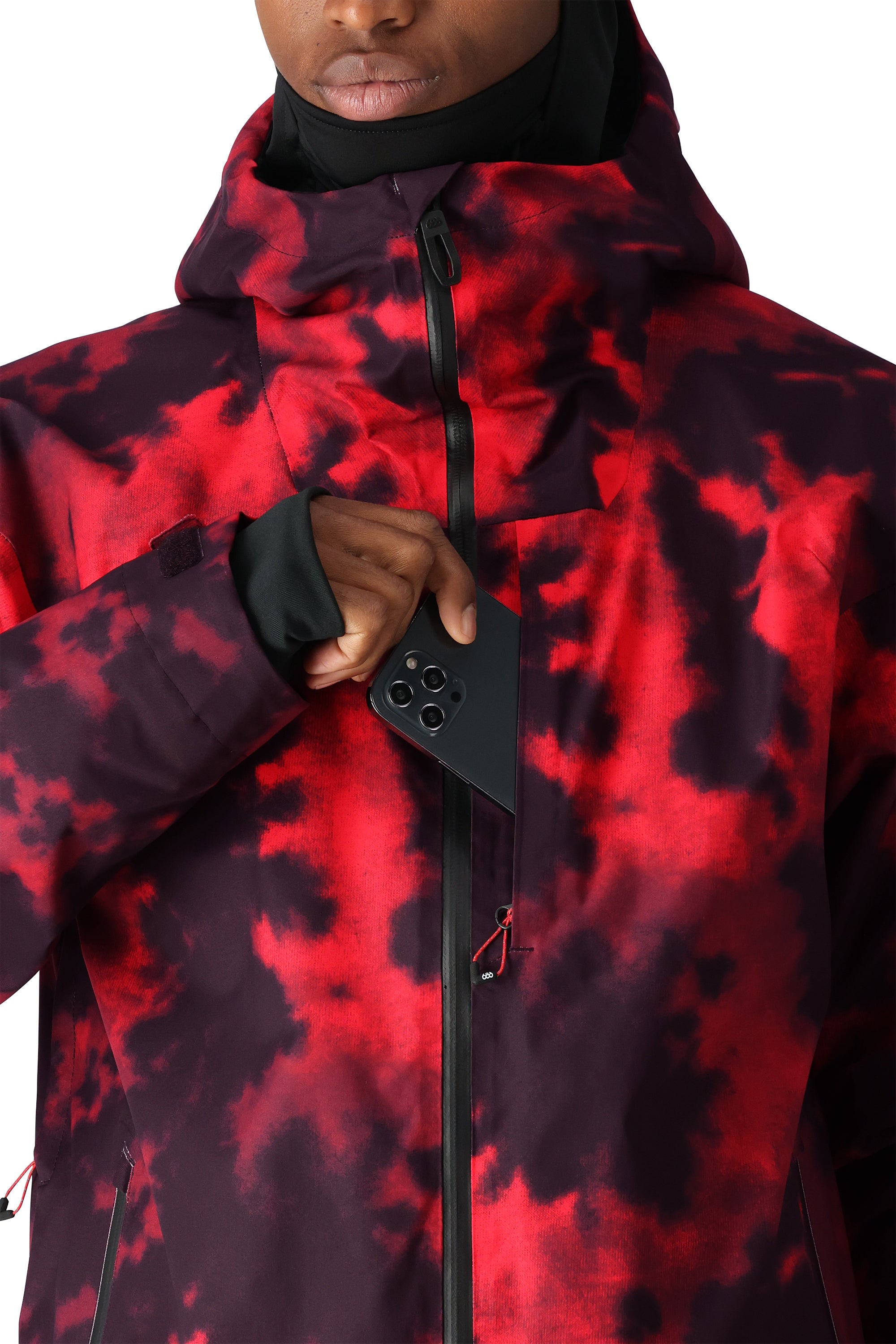 The 686 Gateway Shell Jacket 2025 in red and black tie-dye pattern has an insulated hood.