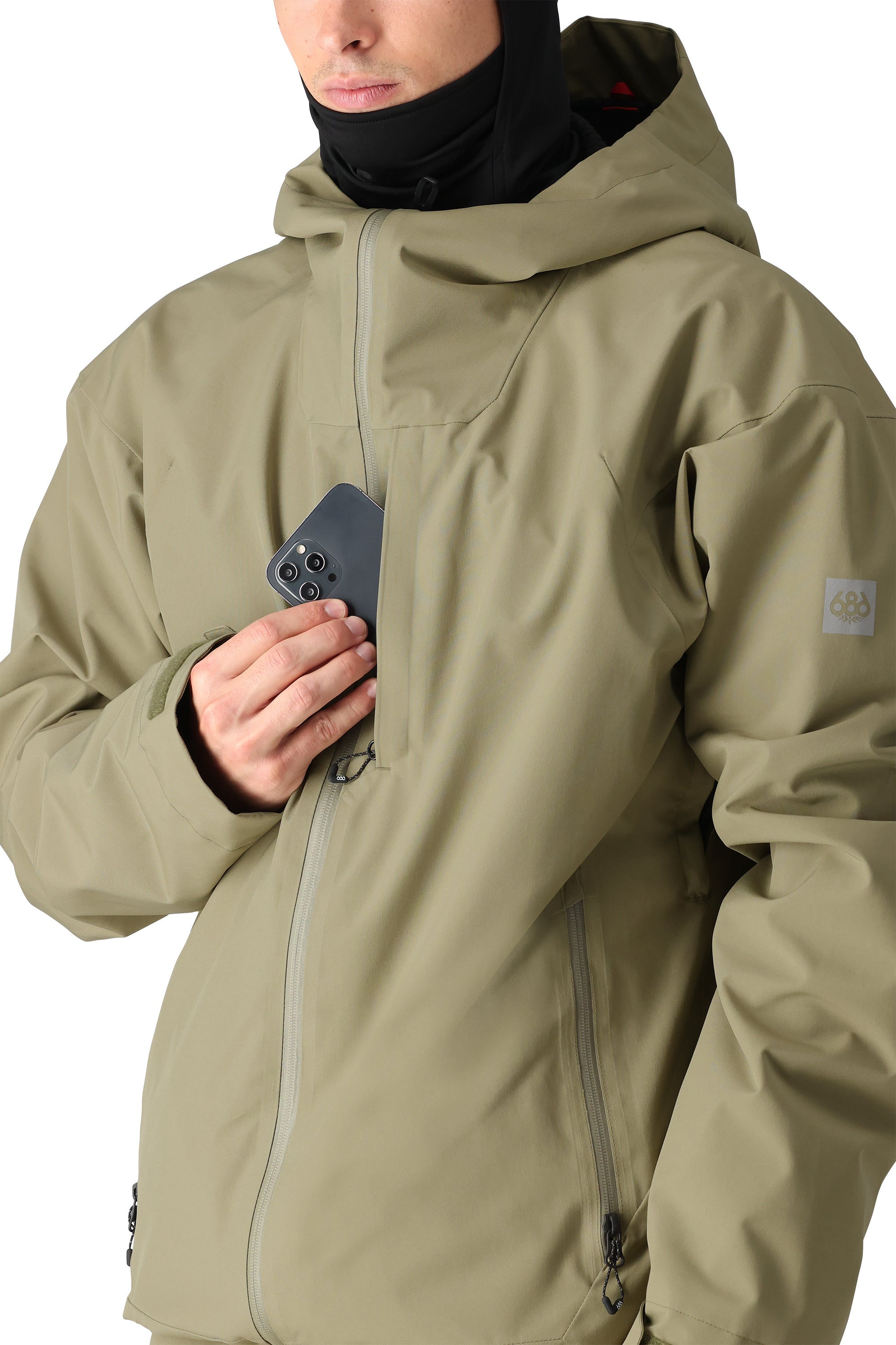 The 686 Gateway Shell Jacket in olive green has an insulated hood and a BOA dial on the left shoulder.