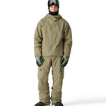 The 686 Gateway Shell Jacket 2025 is primarily khaki green with a black hood and zipper.