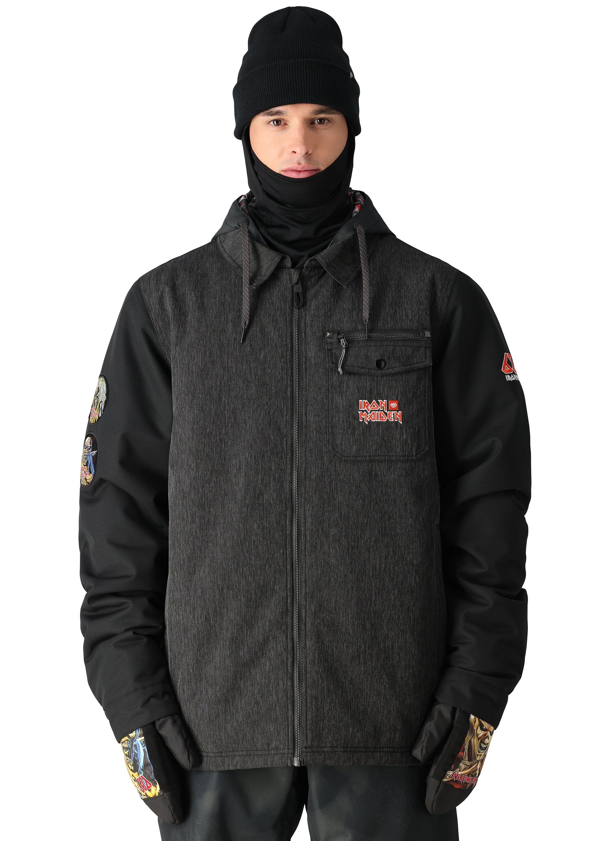 The 686 Iron Maiden Insulated Battle Jacket 2025 is black with an embroidered red and gold Iron Maiden logo on the left chest pocket.