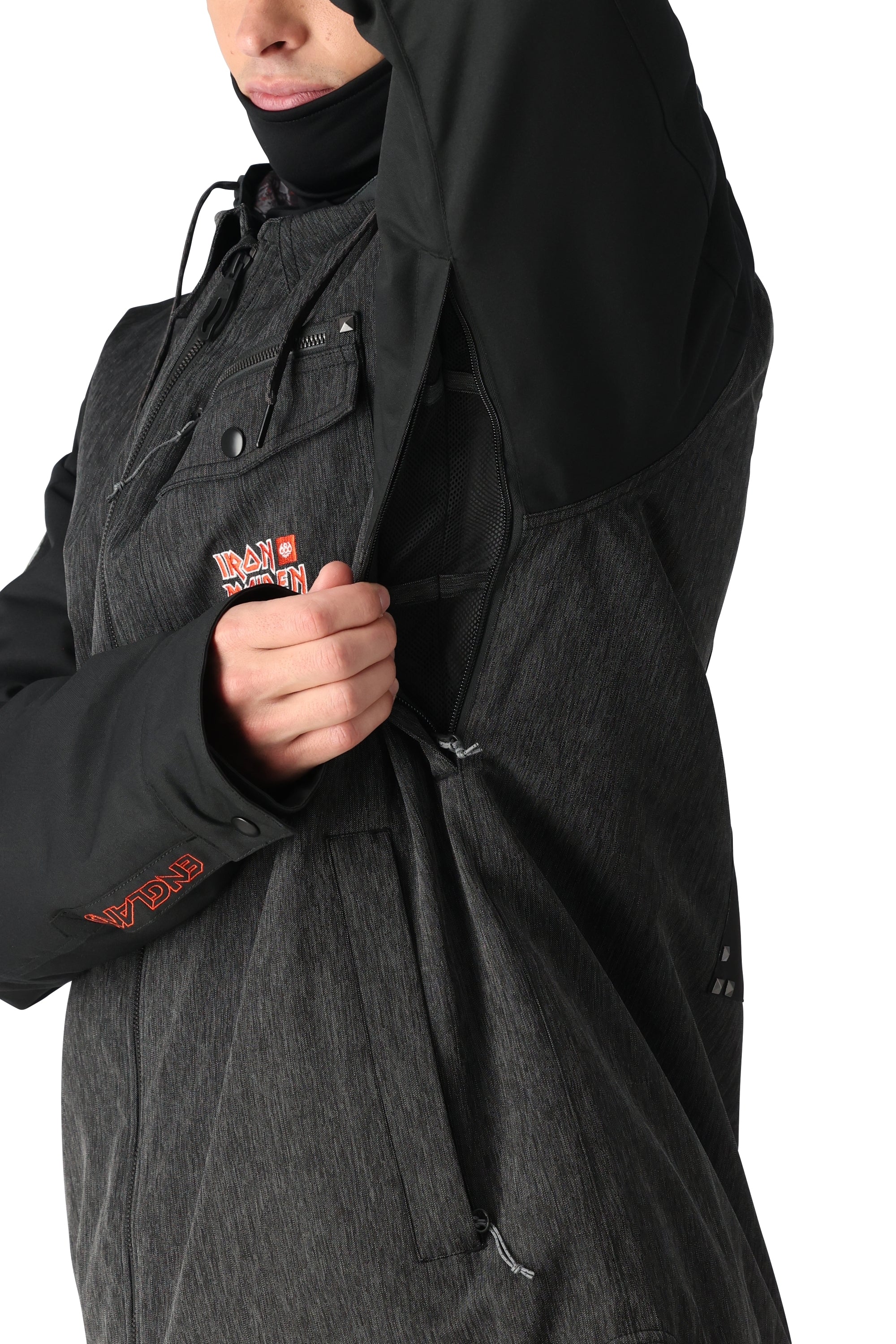 The 686 Iron Maiden Insulated Battle Jacket has an iron maiden logo on the front in white and red.