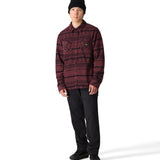 The 686 brand Sierra Fleece Flannel 2025 is showcased in this image, featuring a dark red and black plaid pattern on the front.