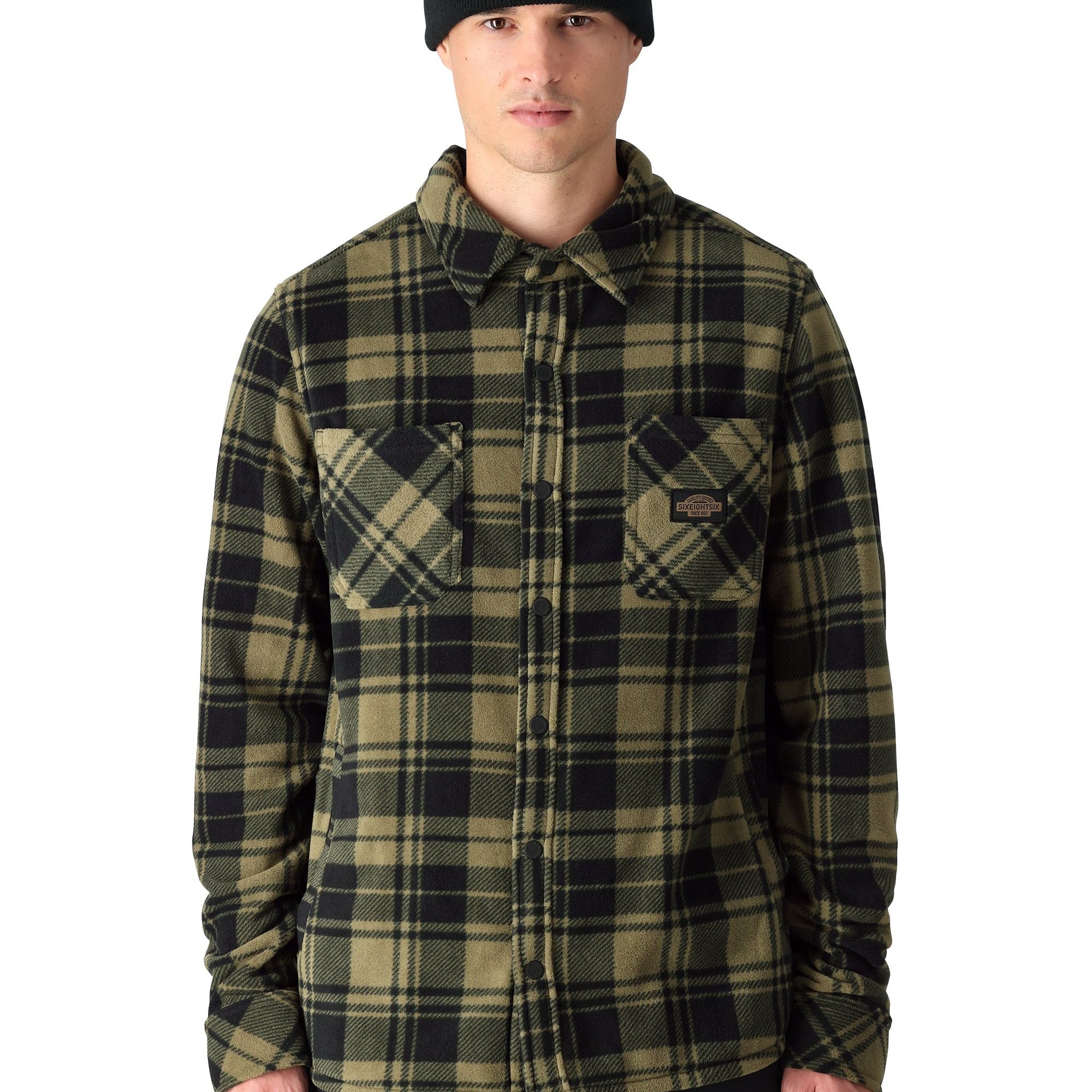 The 686 brand Sierra Fleece Flannel shirt is green and black plaid with a button-down front.