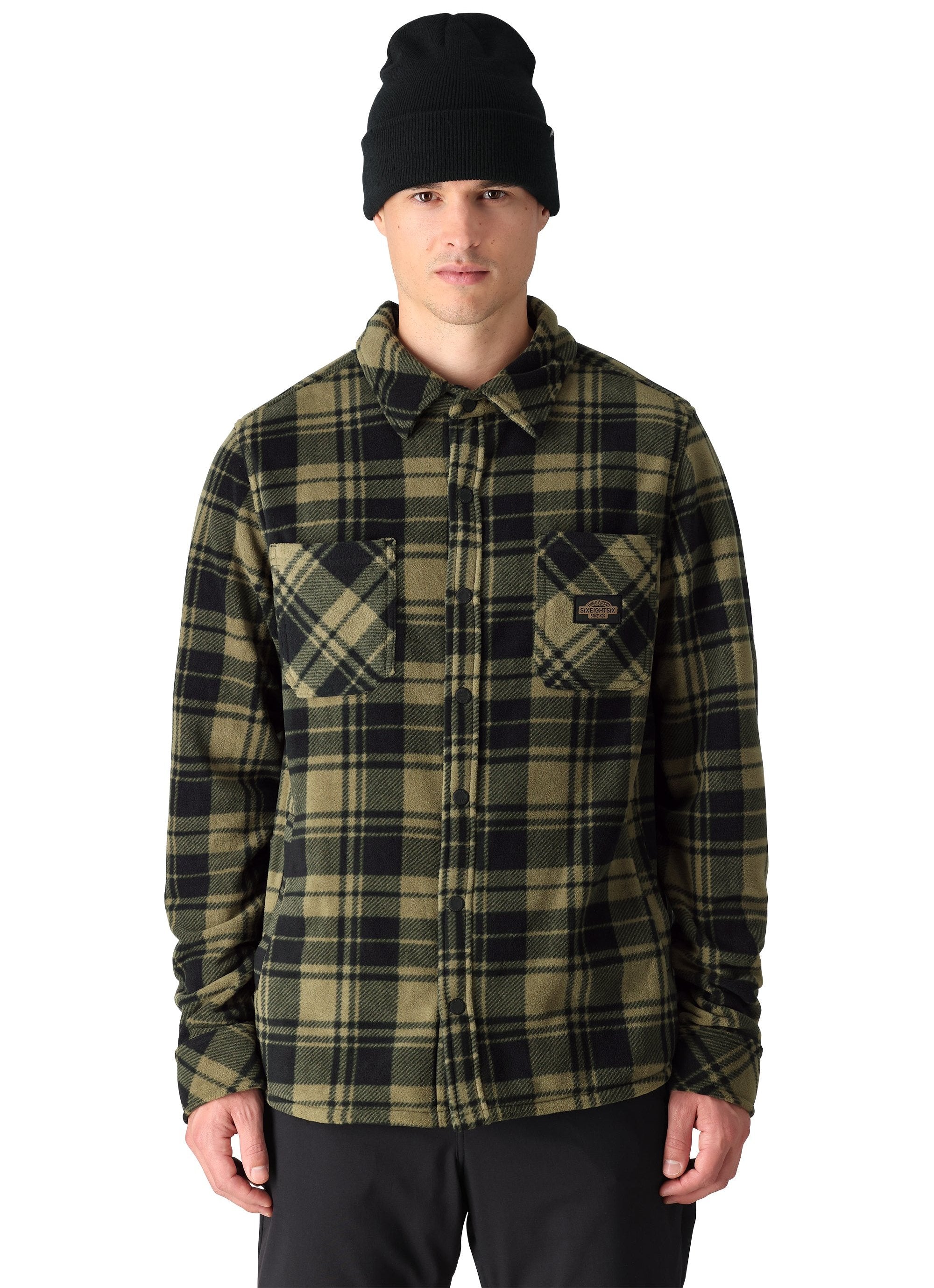 The 686 brand Sierra Fleece Flannel shirt is green and black plaid with a button-down front.