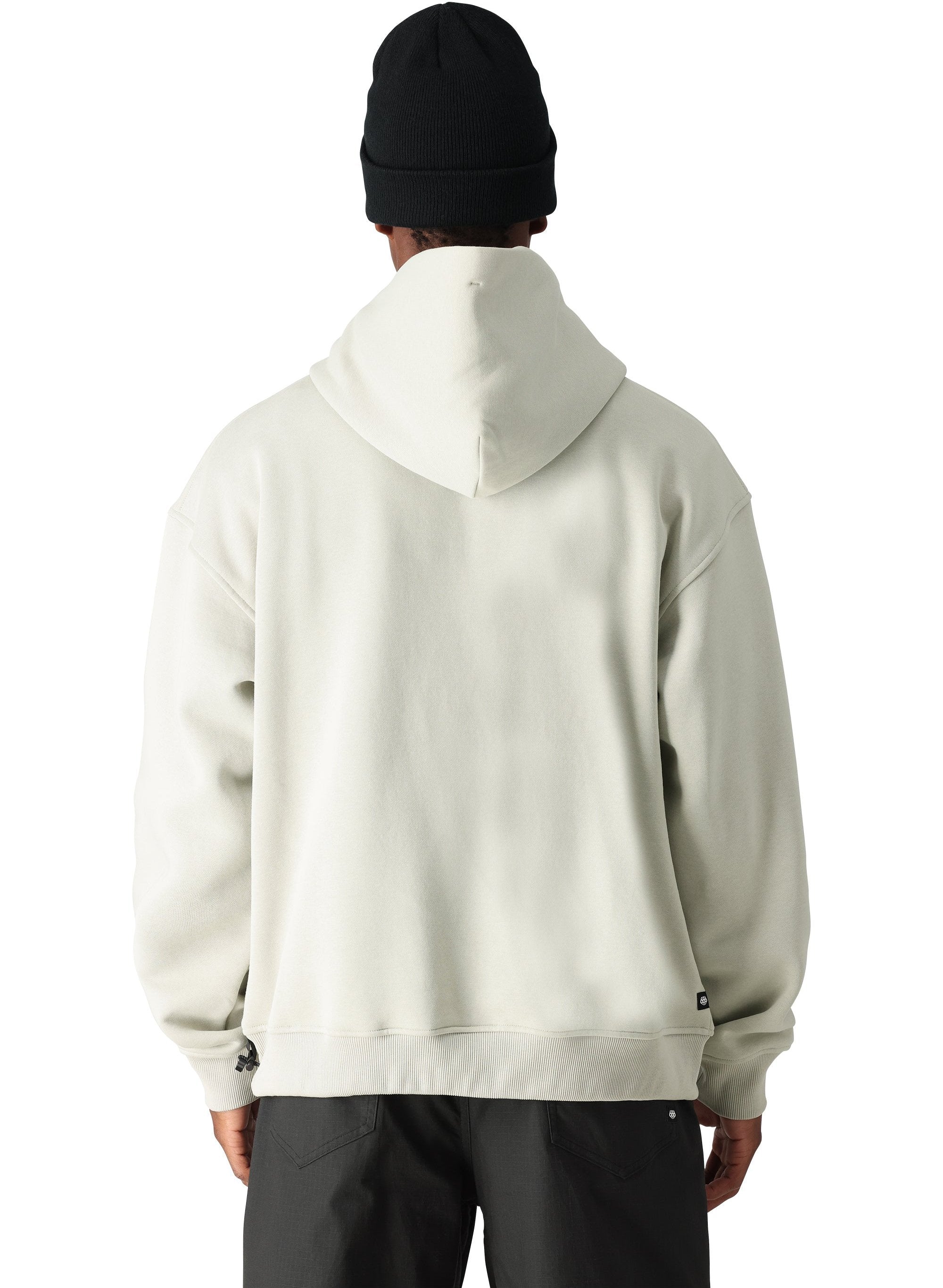 The 686 Men's Vintage Premium Heavyweight Pullover Hoody 2025 is cream-colored with a large front pocket and drawstring hem.