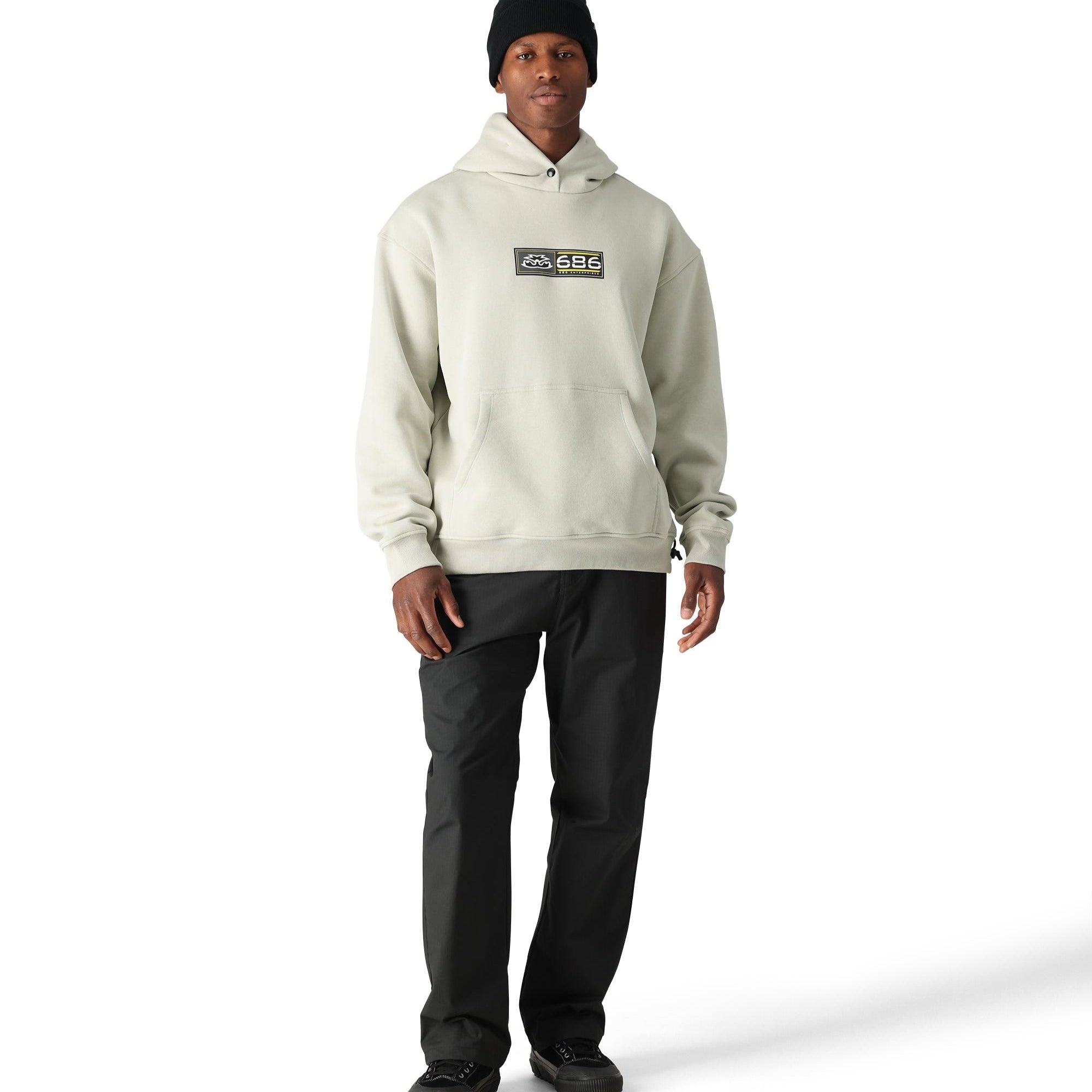 The 686 pullover hoody has a light gray color with a black logo and a kangaroo pocket on the front.